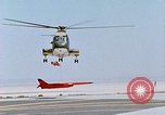 Image of CH-3 helicopter lowers BQM-34 F Firebee drone to ground California United States USA, 1971, second 46 stock footage video 65675067713