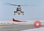 Image of CH-3 helicopter lowers BQM-34 F Firebee drone to ground California United States USA, 1971, second 48 stock footage video 65675067713