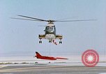 Image of CH-3 helicopter lowers BQM-34 F Firebee drone to ground California United States USA, 1971, second 50 stock footage video 65675067713