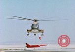 Image of CH-3 helicopter lowers BQM-34 F Firebee drone to ground California United States USA, 1971, second 52 stock footage video 65675067713