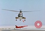 Image of CH-3 helicopter lowers BQM-34 F Firebee drone to ground California United States USA, 1971, second 53 stock footage video 65675067713