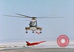 Image of CH-3 helicopter lowers BQM-34 F Firebee drone to ground California United States USA, 1971, second 54 stock footage video 65675067713