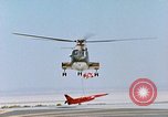 Image of CH-3 helicopter lowers BQM-34 F Firebee drone to ground California United States USA, 1971, second 55 stock footage video 65675067713