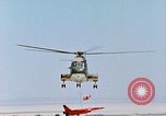 Image of CH-3 helicopter lowers BQM-34 F Firebee drone to ground California United States USA, 1971, second 57 stock footage video 65675067713