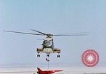 Image of CH-3 helicopter lowers BQM-34 F Firebee drone to ground California United States USA, 1971, second 58 stock footage video 65675067713