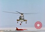 Image of CH-3 helicopter lowers BQM-34 F Firebee drone to ground California United States USA, 1971, second 60 stock footage video 65675067713