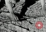 Image of folding a camouflage flat net United States USA, 1942, second 31 stock footage video 65675068405