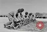 Image of folding a camouflage flat net United States USA, 1942, second 35 stock footage video 65675068405