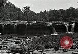 Image of activities near waterfall United States USA, 1916, second 32 stock footage video 65675068418
