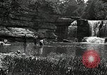 Image of activities near waterfall United States USA, 1916, second 45 stock footage video 65675068418