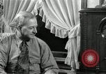 Image of Man listens to vintage radio United States USA, 1935, second 32 stock footage video 65675068706