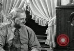 Image of Man listens to vintage radio United States USA, 1935, second 33 stock footage video 65675068706