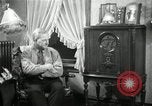 Image of Man listens to vintage radio United States USA, 1935, second 36 stock footage video 65675068706