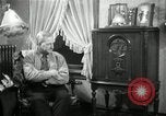 Image of Man listens to vintage radio United States USA, 1935, second 37 stock footage video 65675068706