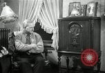 Image of Man listens to vintage radio United States USA, 1935, second 38 stock footage video 65675068706