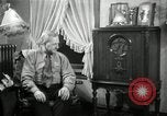 Image of Man listens to vintage radio United States USA, 1935, second 39 stock footage video 65675068706