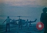 Image of helicopters thrown overboard during fall of Saigon South China Sea, 1975, second 6 stock footage video 65675069511