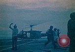 Image of helicopters thrown overboard during fall of Saigon South China Sea, 1975, second 7 stock footage video 65675069511