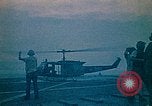 Image of helicopters thrown overboard during fall of Saigon South China Sea, 1975, second 8 stock footage video 65675069511