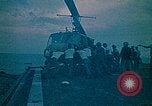Image of helicopters thrown overboard during fall of Saigon South China Sea, 1975, second 9 stock footage video 65675069511