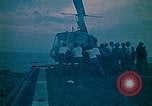 Image of helicopters thrown overboard during fall of Saigon South China Sea, 1975, second 10 stock footage video 65675069511