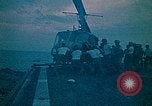 Image of helicopters thrown overboard during fall of Saigon South China Sea, 1975, second 12 stock footage video 65675069511