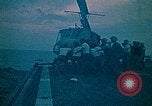 Image of helicopters thrown overboard during fall of Saigon South China Sea, 1975, second 13 stock footage video 65675069511