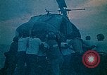 Image of helicopters thrown overboard during fall of Saigon South China Sea, 1975, second 14 stock footage video 65675069511