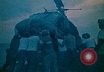 Image of helicopters thrown overboard during fall of Saigon South China Sea, 1975, second 15 stock footage video 65675069511