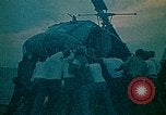 Image of helicopters thrown overboard during fall of Saigon South China Sea, 1975, second 16 stock footage video 65675069511