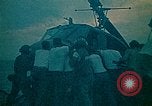 Image of helicopters thrown overboard during fall of Saigon South China Sea, 1975, second 17 stock footage video 65675069511