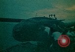 Image of helicopters thrown overboard during fall of Saigon South China Sea, 1975, second 26 stock footage video 65675069511