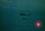 Image of helicopters thrown overboard during fall of Saigon South China Sea, 1975, second 31 stock footage video 65675069511