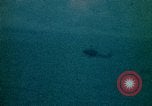Image of helicopters thrown overboard during fall of Saigon South China Sea, 1975, second 33 stock footage video 65675069511