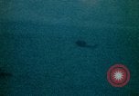 Image of helicopters thrown overboard during fall of Saigon South China Sea, 1975, second 34 stock footage video 65675069511