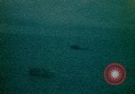 Image of helicopters thrown overboard during fall of Saigon South China Sea, 1975, second 38 stock footage video 65675069511
