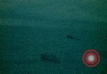 Image of helicopters thrown overboard during fall of Saigon South China Sea, 1975, second 39 stock footage video 65675069511
