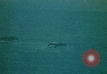 Image of helicopters thrown overboard during fall of Saigon South China Sea, 1975, second 48 stock footage video 65675069511