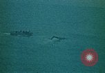 Image of helicopters thrown overboard during fall of Saigon South China Sea, 1975, second 50 stock footage video 65675069511
