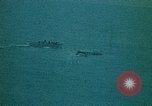 Image of helicopters thrown overboard during fall of Saigon South China Sea, 1975, second 52 stock footage video 65675069511