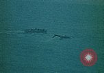 Image of helicopters thrown overboard during fall of Saigon South China Sea, 1975, second 53 stock footage video 65675069511