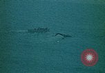 Image of helicopters thrown overboard during fall of Saigon South China Sea, 1975, second 54 stock footage video 65675069511