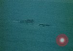 Image of helicopters thrown overboard during fall of Saigon South China Sea, 1975, second 55 stock footage video 65675069511