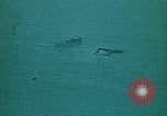 Image of helicopters thrown overboard during fall of Saigon South China Sea, 1975, second 58 stock footage video 65675069511