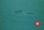 Image of helicopters thrown overboard during fall of Saigon South China Sea, 1975, second 59 stock footage video 65675069511
