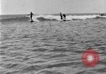 Image of Hawaiian people surfing Honolulu Hawaii USA, 1924, second 50 stock footage video 65675070228