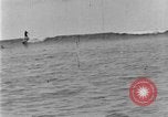 Image of Hawaiian people surfing Honolulu Hawaii USA, 1924, second 56 stock footage video 65675070228