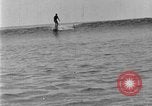 Image of Hawaiian people surfing Honolulu Hawaii USA, 1924, second 59 stock footage video 65675070228