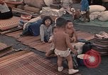 Image of ethnic Vietnamese fleeing Cambodia Vung Tau Vietnam, 1970, second 32 stock footage video 65675070855