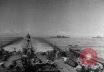 Image of Silhouettes of U.S. Army soldiers boarding a troop transport ship. Pacific Theater, 1942, second 1 stock footage video 65675071824